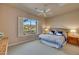 Bright bedroom with large window, shutters, ceiling fan, and coordinated decor at 3109 W Summit Walk Ct, Anthem, AZ 85086