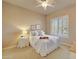 Bright bedroom with a plush bed, side table, shuttered window, and framed artwork at 3109 W Summit Walk Ct, Anthem, AZ 85086