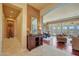 Welcoming foyer with a wood buffet, mirror, and an arched view to the dining and living area at 3109 W Summit Walk Ct, Anthem, AZ 85086