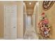 Hallway with neutral walls, tile flooring, and decorative floral arrangement at 3109 W Summit Walk Ct, Anthem, AZ 85086