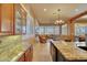 Gourmet kitchen open to the living room, with granite counters and stainless steel sink at 3109 W Summit Walk Ct, Anthem, AZ 85086