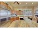 Kitchen showcasing stainless steel refrigerator, granite countertops, and eat-in island at 3109 W Summit Walk Ct, Anthem, AZ 85086