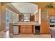 Kitchen bar area with wine storage, granite countertops, and views into the main living space at 3109 W Summit Walk Ct, Anthem, AZ 85086