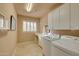 Bright laundry room features a washer and dryer, storage cabinets, and a window with lots of natural light at 3109 W Summit Walk Ct, Anthem, AZ 85086