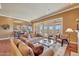 Bright living room with hardwood floors, large windows, and an open concept leading to the kitchen at 3109 W Summit Walk Ct, Anthem, AZ 85086