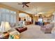 Open living area with a view into the kitchen, and a comfortable seating arrangement at 3109 W Summit Walk Ct, Anthem, AZ 85086