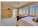 Bright main bedroom with sunny windows, comfortable sitting area and built in cabinet at 3109 W Summit Walk Ct, Anthem, AZ 85086