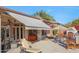 Inviting backyard patio area with an outdoor kitchen, pool, and a retractable awning at 3109 W Summit Walk Ct, Anthem, AZ 85086