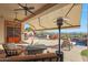 Covered outdoor patio with ceiling fans, fireplace, outdoor kitchen, and stunning mountain views at 3109 W Summit Walk Ct, Anthem, AZ 85086