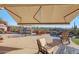 Outdoor living area with a covered patio, kitchen, fireplace, and relaxing water feature at 3109 W Summit Walk Ct, Anthem, AZ 85086