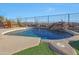 Beautiful swimming pool featuring a rock waterfall, desert landscaping, a view fence, and seating area at 3109 W Summit Walk Ct, Anthem, AZ 85086