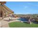 Inviting backyard pool with a rock waterfall feature and beautiful desert landscaping at 3109 W Summit Walk Ct, Anthem, AZ 85086