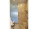 Walk-in shower featuring a glass block partition, bench seat and tiled walls at 3109 W Summit Walk Ct, Anthem, AZ 85086