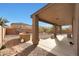 Covered backyard patio, built-in grill area, and palm trees at 3111 W Pleasant Ln, Phoenix, AZ 85041