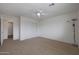 Spacious carpeted bedroom with a ceiling fan and a closet with sliding doors at 3111 W Pleasant Ln, Phoenix, AZ 85041