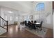 Bright dining room featuring tall ceilings, a large arched window, and a classic table setting at 3111 W Pleasant Ln, Phoenix, AZ 85041