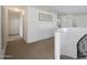 Well-lit hallway featuring a winding staircase to the right as well as a decorative art piece in the center at 3111 W Pleasant Ln, Phoenix, AZ 85041