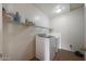 Tidy laundry room with a new washer and dryer unit and wire shelving on the wall at 3111 W Pleasant Ln, Phoenix, AZ 85041