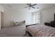 Comfortable main bedroom featuring neutral colors, a ceiling fan, and a sliding door for lots of natural light at 3111 W Pleasant Ln, Phoenix, AZ 85041