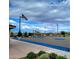 Community basketball court with benches, mature trees, and United States flags at 34825 N Kaden Rd, San Tan Valley, AZ 85144