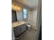 This full bathroom features a gray vanity, wood-look tile flooring, and a shower-tub combo at 34825 N Kaden Rd, San Tan Valley, AZ 85144