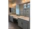 Bathroom featuring double sinks, granite countertops and a glass enclosed shower at 34825 N Kaden Rd, San Tan Valley, AZ 85144