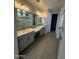 Bathroom featuring dual sinks, modern fixtures, and a spacious glass-enclosed shower at 34825 N Kaden Rd, San Tan Valley, AZ 85144