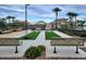 Community bocce ball court featuring seating and mature palm trees at 34825 N Kaden Rd, San Tan Valley, AZ 85144