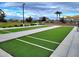 Community bocce ball court bordered by benches and lush landscaping at 34825 N Kaden Rd, San Tan Valley, AZ 85144