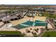 Aerial view of a large community pool with lounge area and picnic tables at 34825 N Kaden Rd, San Tan Valley, AZ 85144