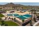 Aerial view of resort-style community pool with umbrellas at 34825 N Kaden Rd, San Tan Valley, AZ 85144