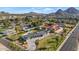 Expansive aerial view featuring a home with lush landscaping, a large pool, and mountain scenery at 3702 E Camelback Rd, Phoenix, AZ 85018