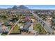 A picturesque aerial view showcasing the property's large lot, sparkling pool, and proximity to the city skyline at 3702 E Camelback Rd, Phoenix, AZ 85018