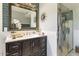 Contemporary bathroom with teal backsplash, a vanity with dark wood cabinets, and a glass-enclosed shower at 3702 E Camelback Rd, Phoenix, AZ 85018