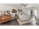 Inviting bedroom with a metal frame bed, vintage dresser, and a light-filled view to the outside at 3702 E Camelback Rd, Phoenix, AZ 85018