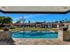 Backyard pool with a clear view of the house featuring lounge chairs, outdoor umbrellas, and a large lawn at 3702 E Camelback Rd, Phoenix, AZ 85018