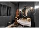 Chic powder room with a black and white checkered floor, dark walls, and ornate mirror at 3702 E Camelback Rd, Phoenix, AZ 85018