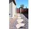 Landscaped backyard featuring a gravel path, stone pavers, and wrought iron gate at 4112 N 11Th St, Phoenix, AZ 85014