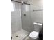 Bright bathroom featuring a tiled walk-in shower with white marble pattern and modern fixtures at 4112 N 11Th St, Phoenix, AZ 85014