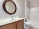 The bathroom features a round mirror over the sink and a shower/bathtub combo at 46072 W Barbara Ln, Maricopa, AZ 85139