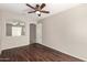 This bedroom features a door, an arched window looking into another room, and wood-look flooring at 46072 W Barbara Ln, Maricopa, AZ 85139