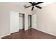 Bedroom featuring wood floors, a closet, and a doorway to another room at 46072 W Barbara Ln, Maricopa, AZ 85139