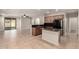 Open concept kitchen with island and stainless steel appliances next to sliding glass door at 46072 W Barbara Ln, Maricopa, AZ 85139