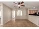 Inviting living area with tile flooring and a ceiling fan for added comfort at 46072 W Barbara Ln, Maricopa, AZ 85139