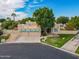 Aerial view of charming single-story home with a well-manicured lawn and multi-car garage at 5345 E Mclellan Rd # 83, Mesa, AZ 85205