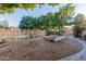 Landscaped backyard with a fenced pool, mature trees, and a gravel area, blending relaxation and nature at 5345 E Mclellan Rd # 83, Mesa, AZ 85205