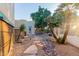 Relaxing backyard featuring desert landscaping, a stone pathway, and lush trees at 5345 E Mclellan Rd # 83, Mesa, AZ 85205