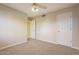 Neutral bedroom featuring beige walls and carpet, with view of closet and door at 5345 E Mclellan Rd # 83, Mesa, AZ 85205