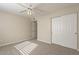 Comfortable bedroom with plush carpeting, a ceiling fan, and a large closet at 5345 E Mclellan Rd # 83, Mesa, AZ 85205