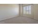 Neutral bedroom featuring large windows with plantation shutters and neutral carpeting at 5345 E Mclellan Rd # 83, Mesa, AZ 85205